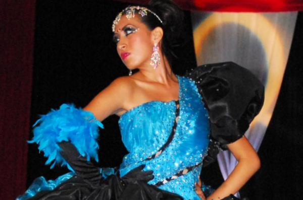 A Quinceanera dancer wearing a blue and black dress