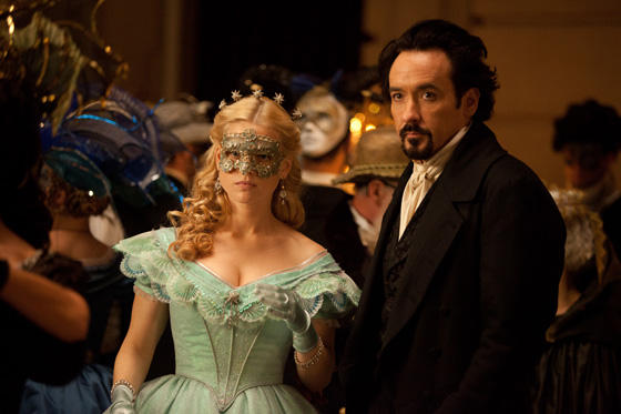 John Cusack dressed in costume with a man and a woman at a Quinceanera event