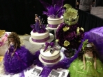 Quinceanera cake with purple ornaments.